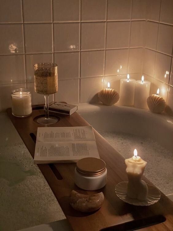 candlelight “Cinnamon vanilla candle glowing beside an open book — fall reading vibe”